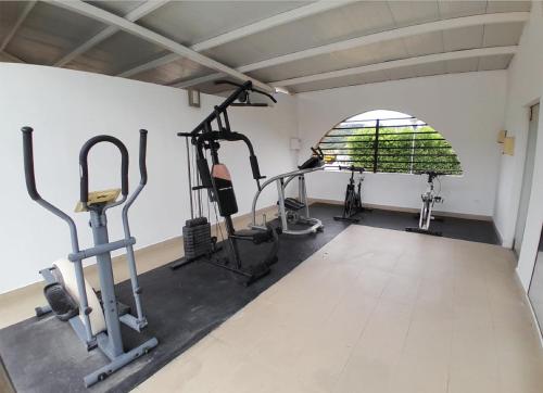 a gym with treadmills and ellipticals in a room at Hotel San Juan Internacional in Bucaramanga