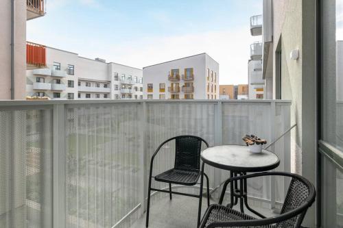 a balcony with two chairs and a table on a balcony at Brand new home in Barkabystaden in Barkarby