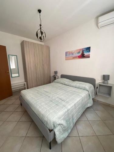 a bedroom with a bed and a chandelier at Saba's House in Ghizzano