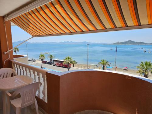 a balcony with a table and a view of the beach at Primera linea - La Manga - Hawaii IV - 1 dormitorio in La Manga del Mar Menor