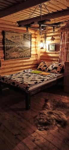 a bed in a room with a wooden cabin at Еко Садиба Під Полониною in Sasivka