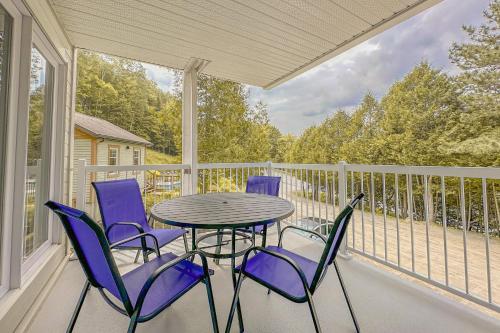 a patio with a table and chairs on a balcony at L'Intemporel by Gestion ELITE in Mont-Tremblant