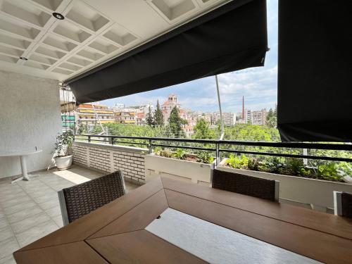 a balcony with a table and chairs and a view at anastasis house in Athens