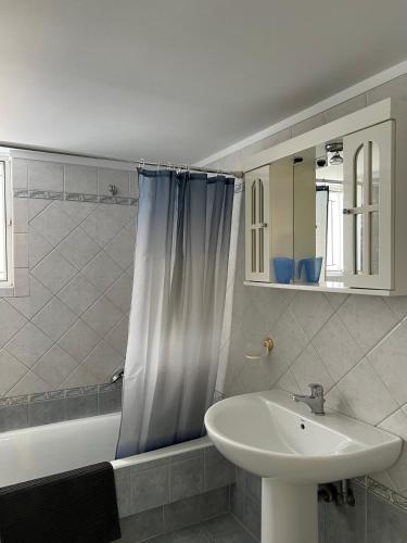 a bathroom with a sink and a bath tub and a sink at anastasis house in Athens