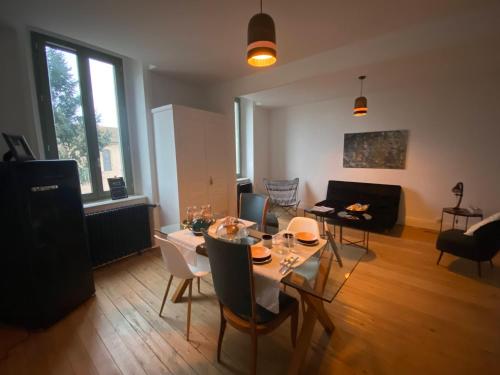 a living room with a dining table and chairs at MY BOUTIQUE GUESTHOUSE - Fabulous Suites 10 Min A7 - in Anneyron