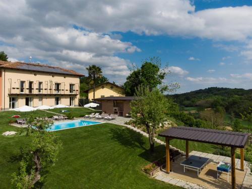 an external view of a house and a swimming pool at Casa San Grato in Monteu Roero