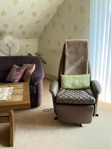 a living room with a chair and a coffee table at Ferienwohnung Paulina in Braunschweig