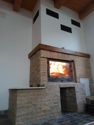 a fireplace with a tv on top of it at Csencsó Vendégház in Ciumani