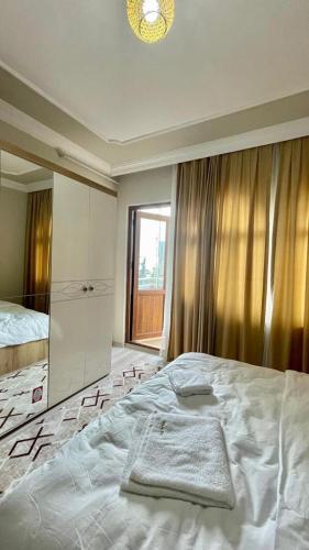 a bedroom with a large bed and a window at KUDÜS APART in Bostancı