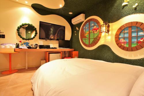 a bedroom with a bed with a tree mural on the wall at Hotel POP3 Jongno in Seoul