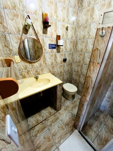 a bathroom with a sink and a toilet at Pousada Recanto Verdes Mares in Arraial do Cabo