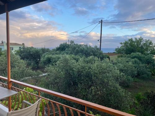 a balcony of a house with a view of trees at Andreas Studios in Svoronata