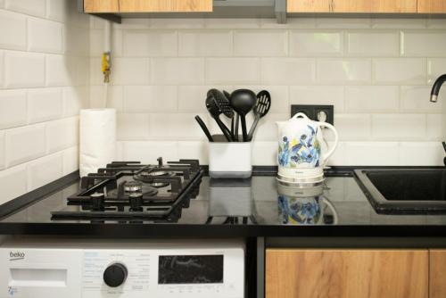 a kitchen counter with a stove and a sink at Urban Home in Kyiv