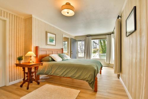 a bedroom with a bed and a table and a window at Sandpiper Shores in Florence