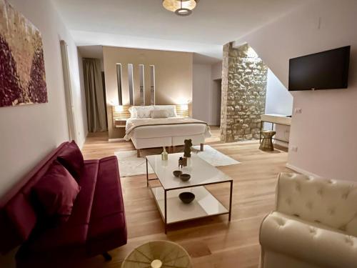 a living room with a bed and a couch at La Piazzetta Suite in Potenza