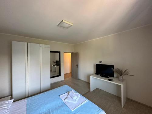 a bedroom with a bed and a television in it at Ribarska Koliba - Villa Rosa in Medulin