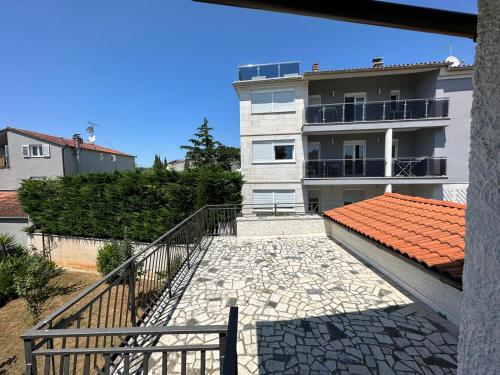a building with a staircase in front of a house at Ribarska Koliba - Villa Rosa in Medulin