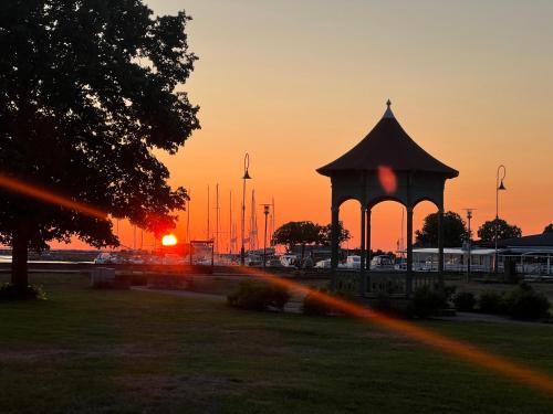 a gazebo in a park with the sunset in the background at Villa Verdi in Borgholm