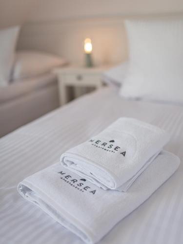 two towels sitting on top of a bed at MERSEA in Ustka