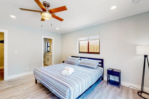 a bedroom with a bed and a ceiling fan at Deerfield Divine in Deerfield Beach