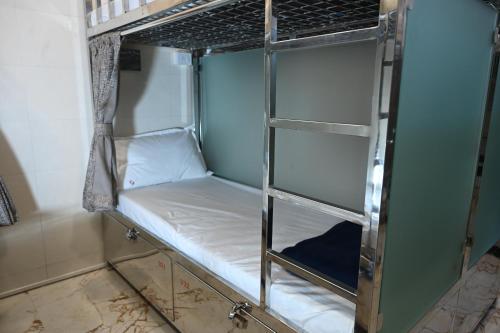 a room with two bunk beds in a room at Sagar Dormitory Andheri - Nearest to Andheri Railway Station West in Mumbai