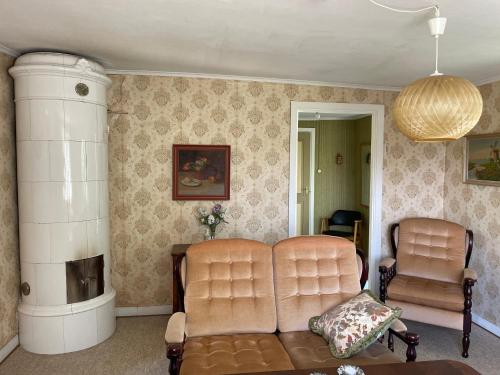 two chairs and a couch in a living room at Cottage with beautiful nature, open landscape, forest and lakes I X I Stuga med fin natur, öppna landskap, skog och sjöar in Tingsryd