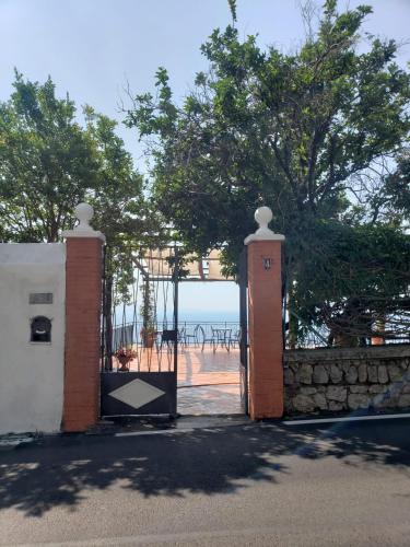 an open gate with a view of the beach at Villa Pino in Furore