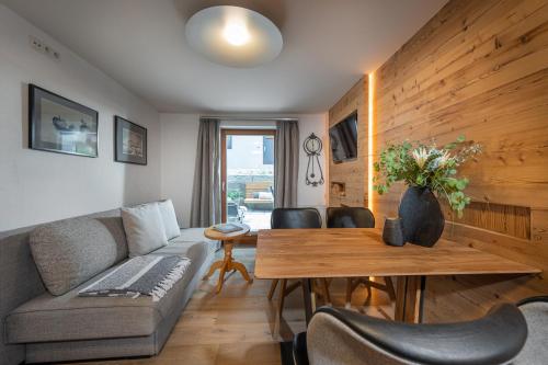 a living room with a couch and a table at Meerberg in Pertisau