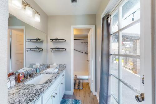 a bathroom with a sink and a large window at Pleasant Daydreams in Chandler