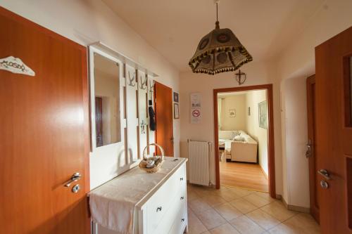 a kitchen with a counter and a hallway at Völgykapu Vendégház in Monostorapáti