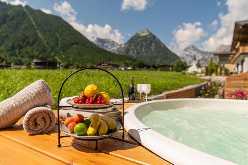 a tray of fruit on a table next to a bath tub at Meerberg in Pertisau
