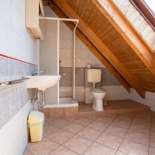 a bathroom with a sink and a toilet at Pizza Sztori Apartman in Balatonmáriafürdő