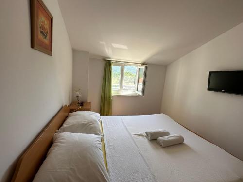 a bedroom with a bed with two towels on it at Apartments Brkić in Lozovac