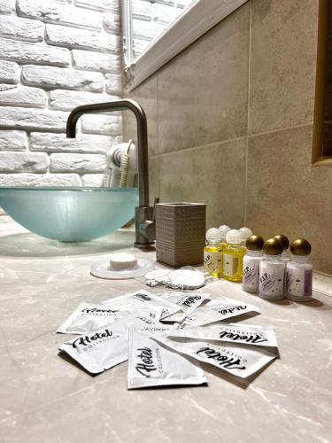 a bathroom counter with towels and a sink and a tub at Edelweiss House in Svityazʼ