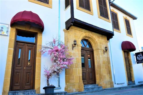 a building with flowers on the side of it at NAGAS Boutique Hotel & Restaurant at at Historical Part of Nicosia in Lefkosa Turk