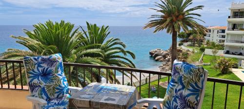 a balcony with two chairs and a view of the ocean at Acapulco Playa beautiful SeaView in Nerja