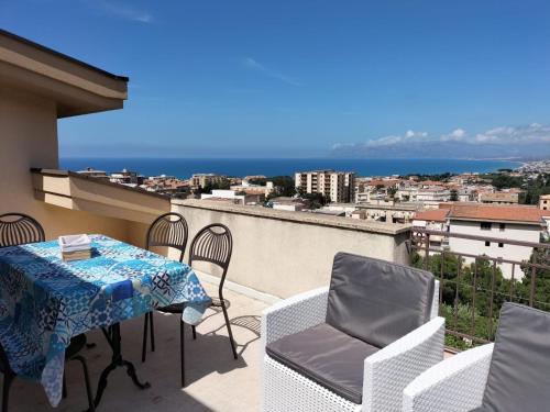a balcony with a table and chairs and the ocean at Villa Rizzo in Castellammare del Golfo
