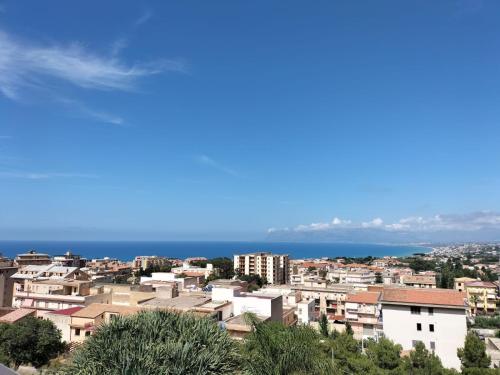 a view of a city with the ocean in the background at Villa Rizzo in Castellammare del Golfo