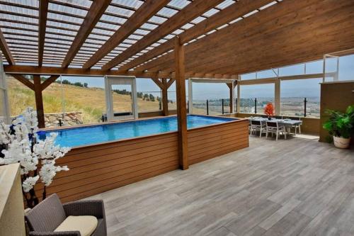 a pool in a house with a view of the ocean at לאגו בוטיק - אירוח למשפחות, זוגות עם בריכה פרטית ונוף in Nof Kinneret