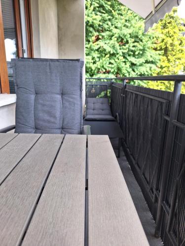 a row of wooden tables and chairs on a balcony at Guesthouse Flower in Ljubljana