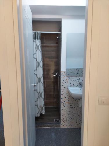 a bathroom with a shower and a sink at Saranda Boutique Hostel in Sarandë