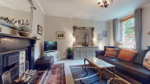 a living room with a couch and a fireplace at Elgin Tower apartment in Minehead