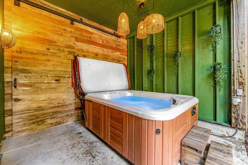 a bath tub in a room with a wooden wall at Cabernet Cabin in Guerneville