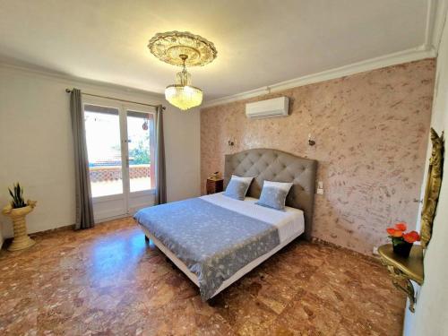a bedroom with a bed and a large window at Villa Marseille dans les hauteurs in Marseille