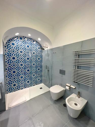 a bathroom with a white toilet and a sink at Villa Alba d'Oro - Historic luxury villa in Amalfi