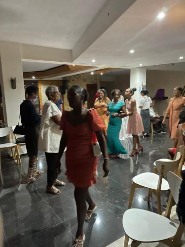 a group of people dancing in a room at Pendora Appartements in Mindelo