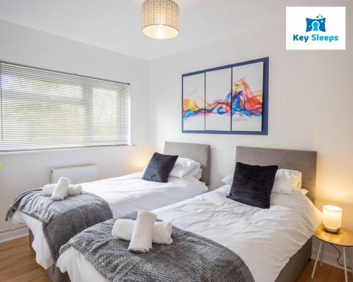 a bedroom with two beds and a window at Beachside Family Staycation at Keysleeps - Pembrokeshire - Free Parking in Pembrokeshire