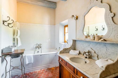 y baño con lavabo, bañera y espejo. en La Bastide des Saveurs en Laouque