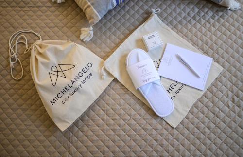 a pair of shoes and a bag on a bed at Michelangelo City Luxury Lodge in Kos Town