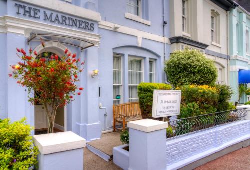 a blue building with a sign in front of it at The Mariners - Torquay in Torquay